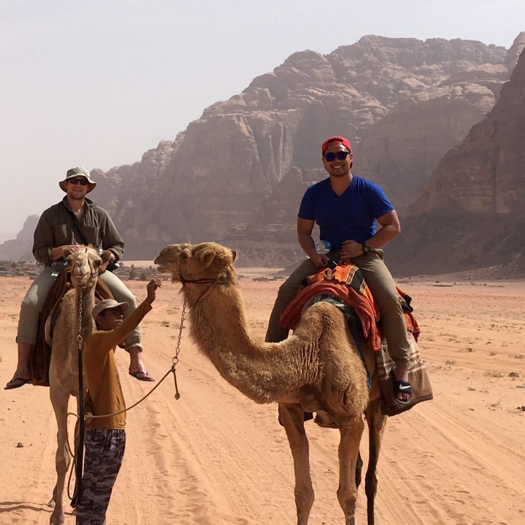 Dave Nguyen riding camel in Jordan